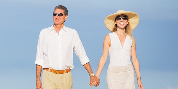 Couple on White Holding Hands Together