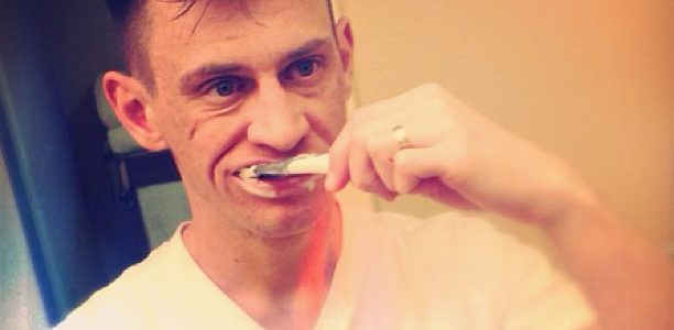 person cleaning teeth